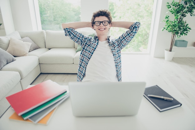 Handsome young guy at home wearing casual checkered shirt