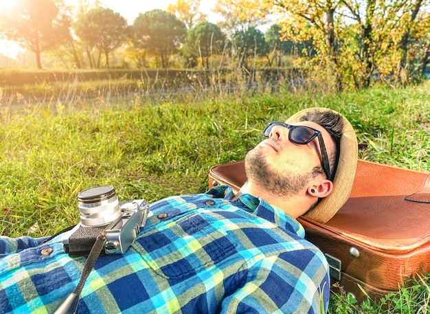 Handsome young hipster relaxing  outdoor