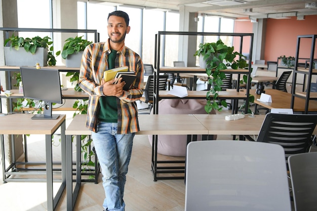 Photo handsome young indian boy student with books and backpack at university education concept