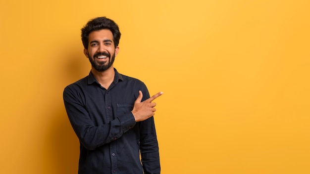 Handsome young indian man pointing aside at copy space with hand