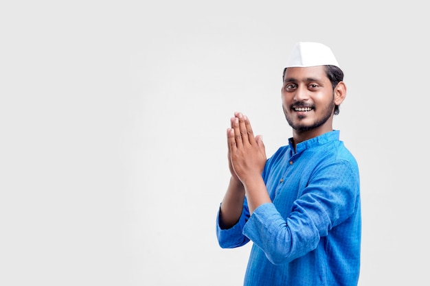 Handsome Young Indian Man Showing Namaste or welcome gesture, Isolated on White Background