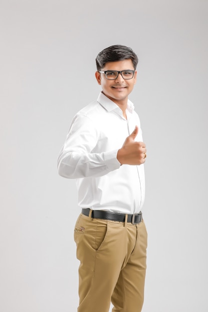 Handsome young Indian man showing thumps up isolated