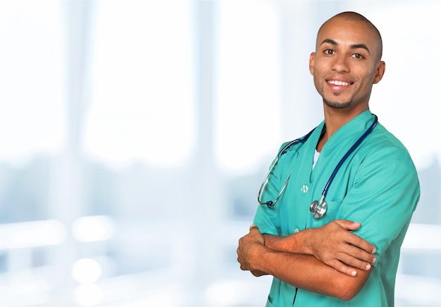 Handsome young male doctor on background