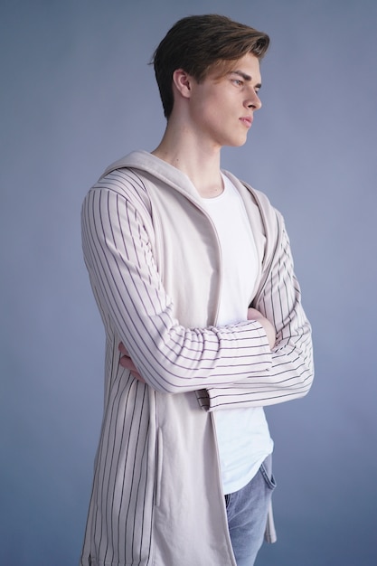 Handsome young male model in a knitted coat