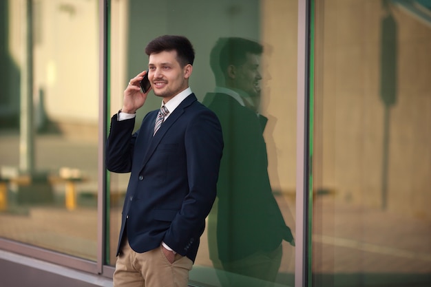 handsome young male in suit with mobile phone