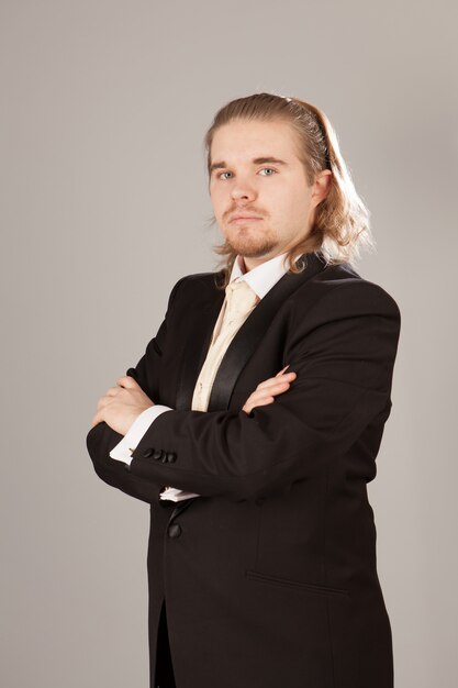 Handsome young man in a black tuxedo