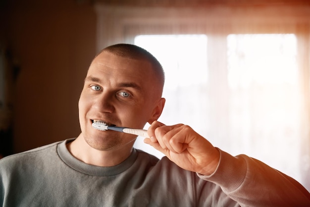 Handsome young man brushing his teeth Oral care concept