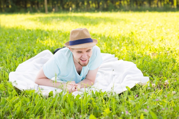 Handsome young man at countryside, in front of field wearing shirt, looking to camera smiling