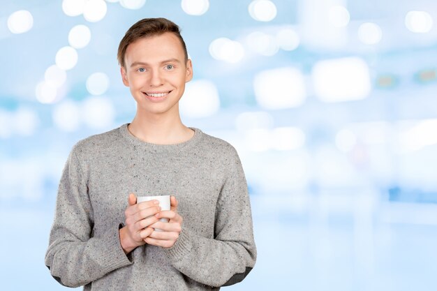 Handsome young man drinking coffee