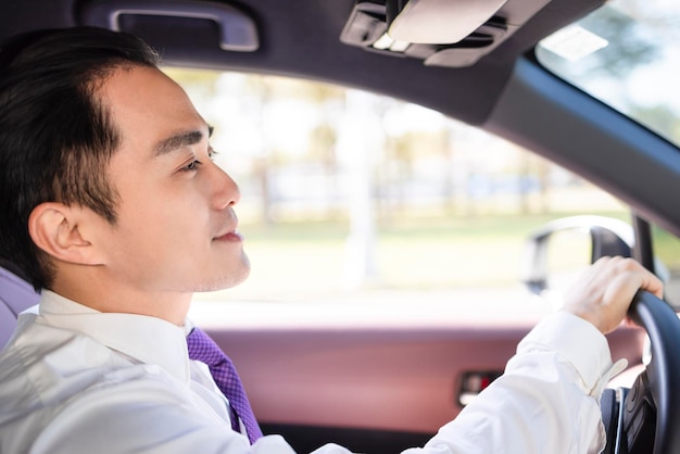 Handsome young man driving the car