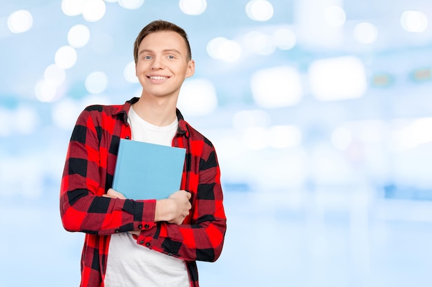 Handsome young man holding books