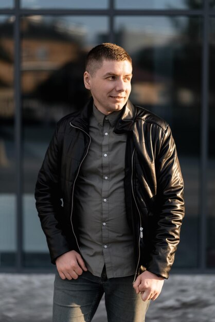 A handsome young man is walking on the city street