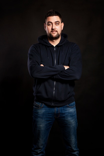 Handsome young man in jeans with a beard