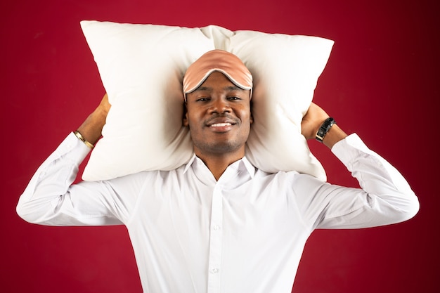 handsome young man lying on a pillow