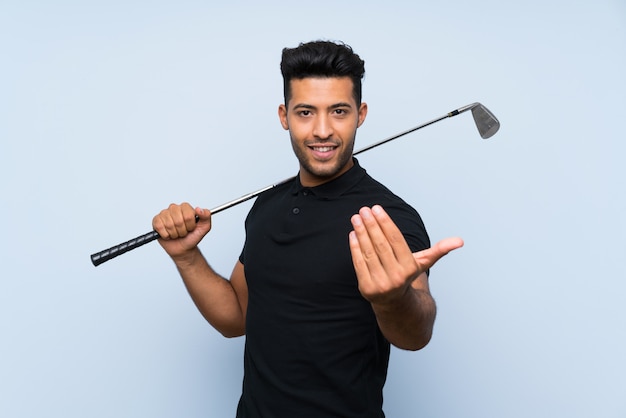 Handsome young man playing golf inviting to come with hand. Happy that you came