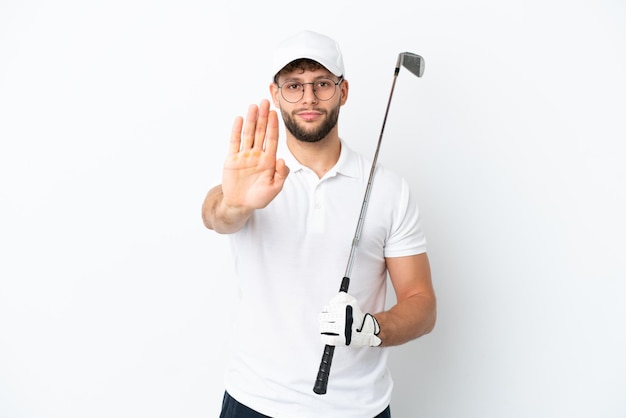 Handsome young man playing golf  isolated on white background making stop gesture