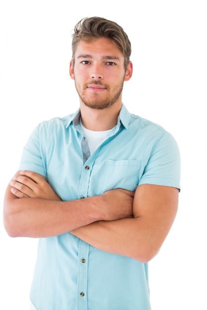 Handsome young man posing with arms crossed