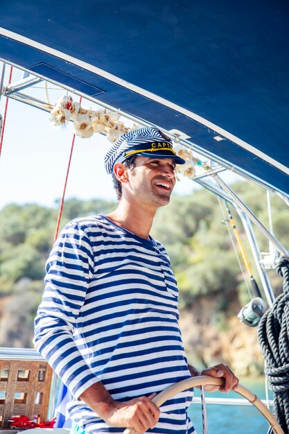 Handsome young man on a sailboat