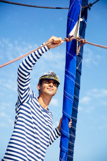 Handsome young man on a sailboat