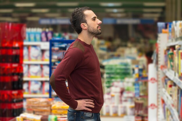 Handsome Young Man Shopping For Fruits And Vegetables In Produce Department Of A Grocery Store  Supermarket  Shallow Deep Of Field