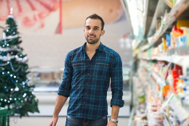 Handsome Young Man Shopping For Fruits And Vegetables In Produce Department Of A Grocery Store  Supermarket  Shallow Deep Of Field