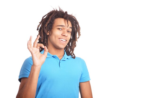 Handsome young man showing ok against white background