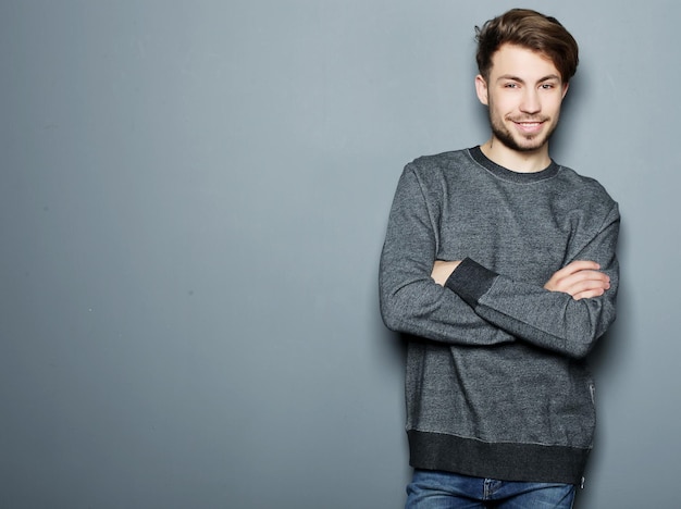 Handsome young man in smart casual wear looking at camera