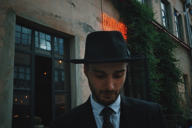 handsome young man standing against building in city