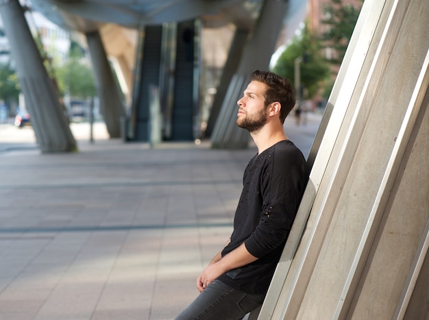 Handsome young man standing outdoors in the city