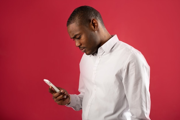 handsome young man in white shirt with phone