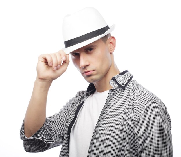 Handsome young man with hat isolated on white background