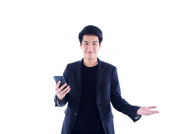 Handsome young man with smartphone over white wall. Space for text