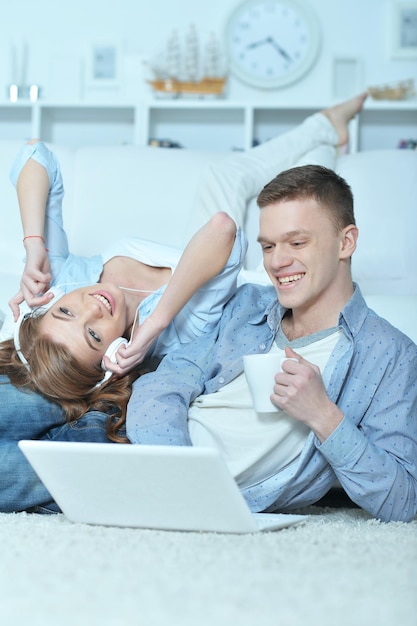 Handsome young man and woman with laptop