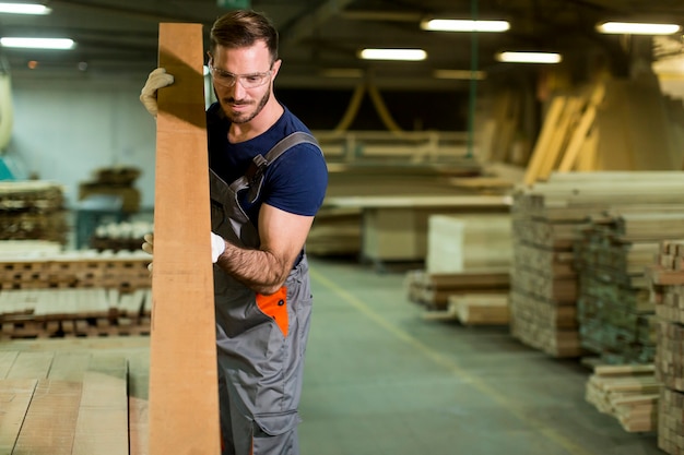 Handsome young man working in the furniture factory