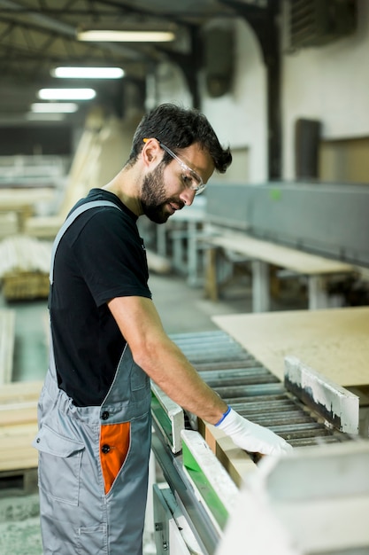 Handsome young man working in the lumber factory