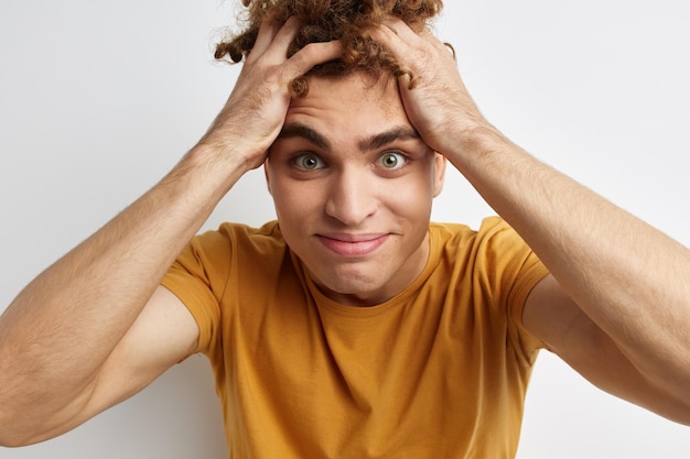 Handsome young man in yellow tshirts gesture hands emotions lifestyle unaltered