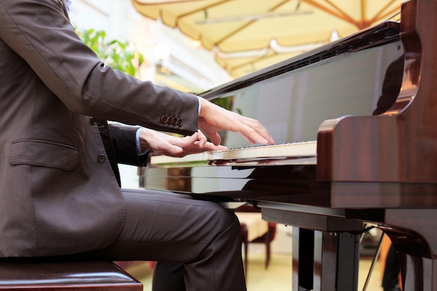 Handsome young men playing piano