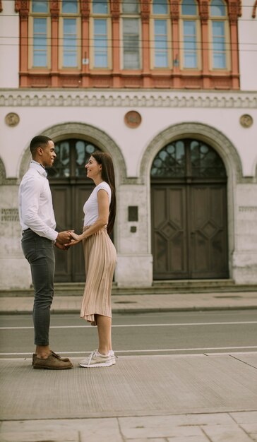 Handsome young multiethnic couple standing on the street