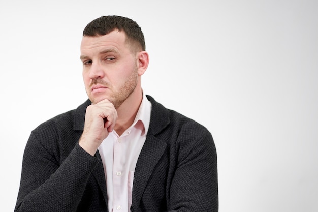 Handsome young pensive man standing