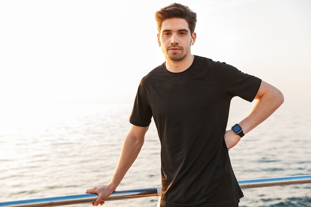 Handsome young sportsman in black shirt