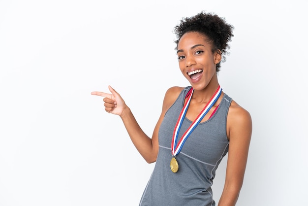 Handsome young tennis player man over isolated white wall smiling and showing victory sign