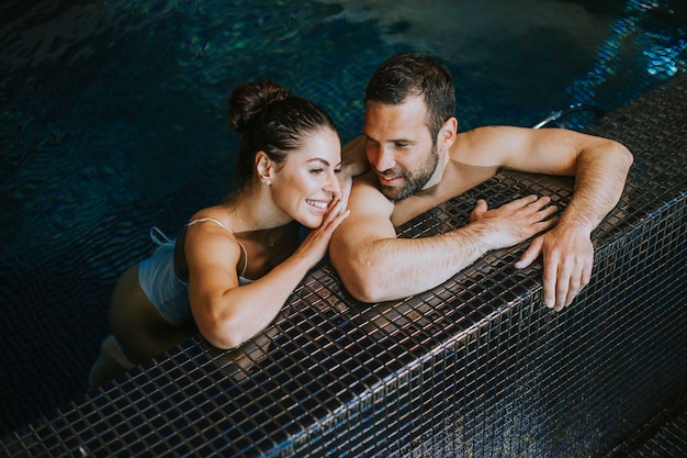 Handsome youple relaxing in a indoor swimming pool