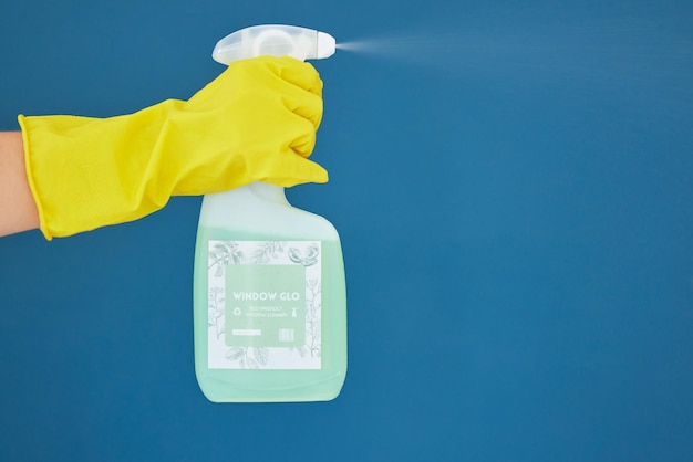 Handspray en wasmiddel voor het reinigen van hygiëne of antibacteriële chemische stof tegen een blauwe studioachtergrond Handen van handschoenspuitvloeistoffles voor het wassen van schoon sanitair of desinfectie op mockup