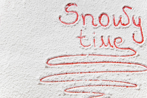 Handwritten text Snowy time on the snowy backgroun