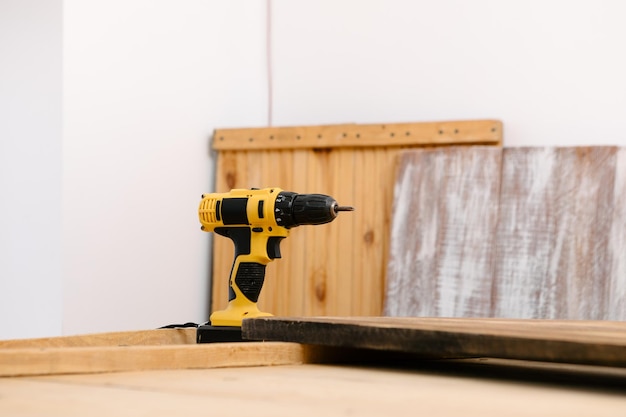 Handyman in blue uniform works with electricity automatic
screwdriver house renovation conception