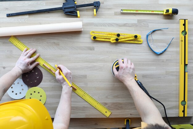 Handyman holding sander machine