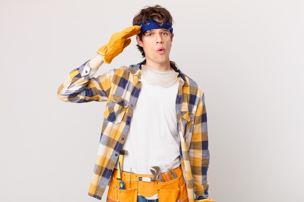 Handyman housekeeper looking happy, astonished and surprised