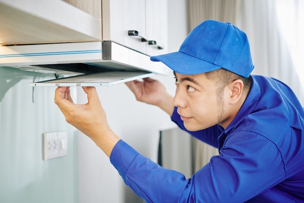 Handyman installing cooker hood