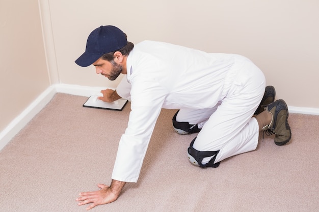 Handyman laying down a carpet