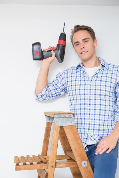 Handyman using cordless drill to the ceiling